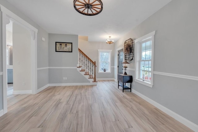 260 Main St Unit 12, Blackstone, MA 01504 - entrance foyer with a chandelier, stairs, light wood-style floors, and baseboards