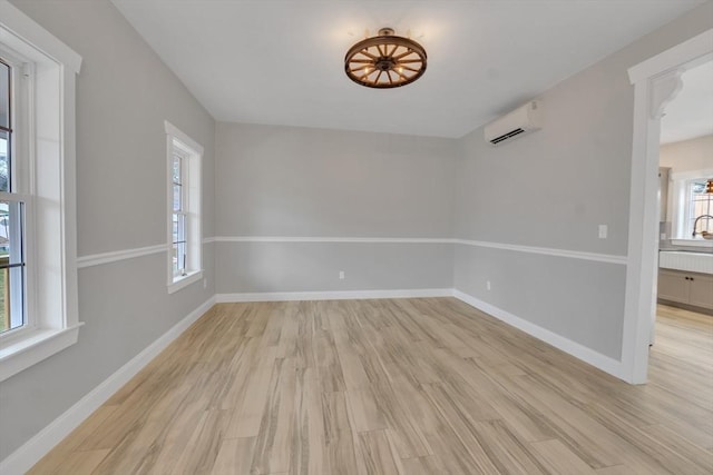 260 Main St Unit 12, Blackstone, MA 01504 - empty room featuring a wall mounted AC, light wood-type flooring, and baseboards