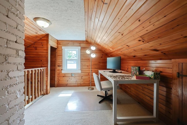 home office with wooden walls, vaulted ceiling, and carpet floors