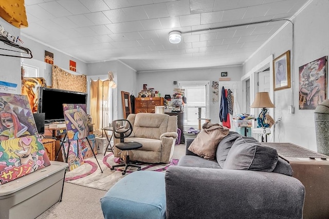 carpeted living room with ornamental molding