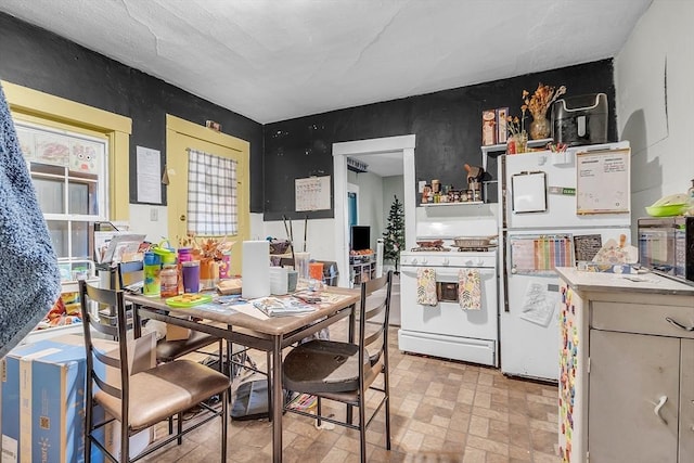 kitchen featuring white appliances and white cabinetry