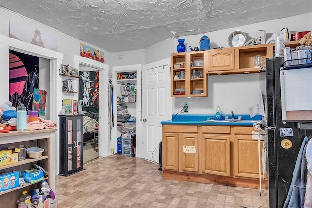 kitchen featuring sink and a textured ceiling