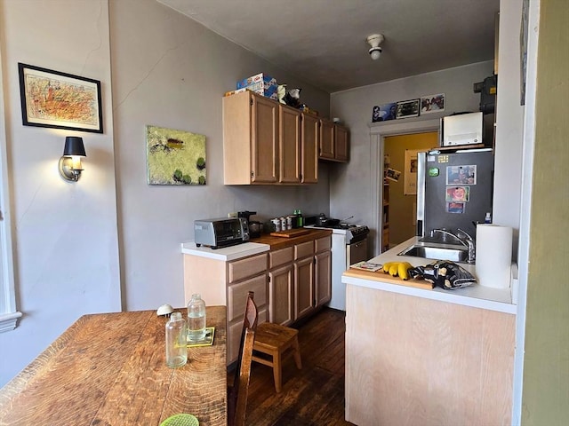 5 Crawford St Unit 9, Cambridge, MA 02139 - kitchen with white gas range oven, freestanding refrigerator, a sink, dark wood-style flooring, and light countertops