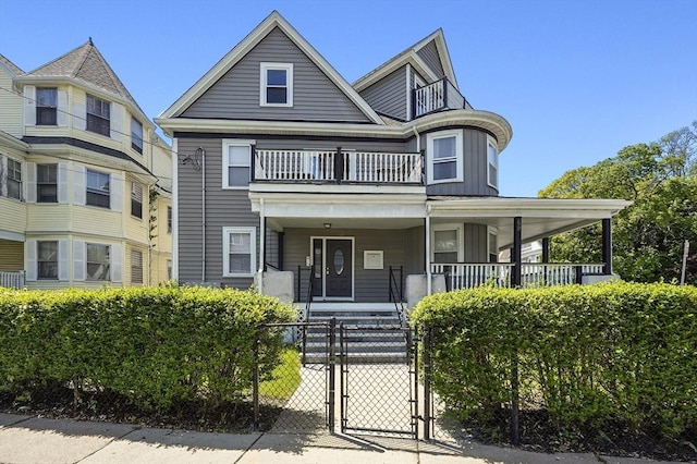 69 Greenwood St, Boston, MA 02122 - victorian-style house featuring a gate, board and batten siding, a porch, a fenced front yard, and a balcony