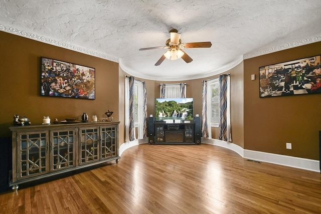 69 Greenwood St, Boston, MA 02122 - living room with a ceiling fan, wood finished floors, baseboards, a textured ceiling, and ornamental molding