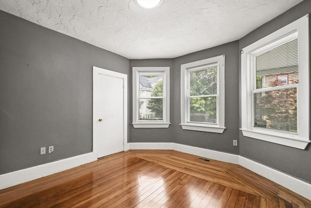 69 Greenwood St, Boston, MA 02122 - empty room with wood-type flooring, baseboards, and a textured ceiling