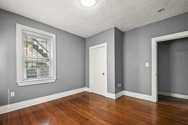 69 Greenwood St, Boston, MA 02122 - unfurnished bedroom featuring wood-type flooring and baseboards