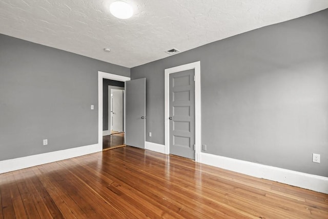 69 Greenwood St, Boston, MA 02122 - spare room featuring baseboards, hardwood / wood-style flooring, and a textured ceiling