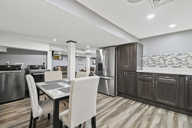 69 Greenwood St, Boston, MA 02122 - dining space featuring washer / clothes dryer, light wood finished floors, and recessed lighting