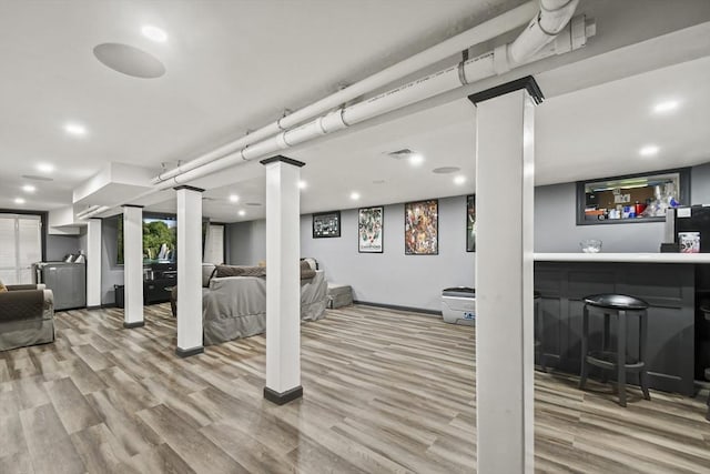 69 Greenwood St, Boston, MA 02122 - finished below grade area featuring wood finished floors, bar area, recessed lighting, and baseboards