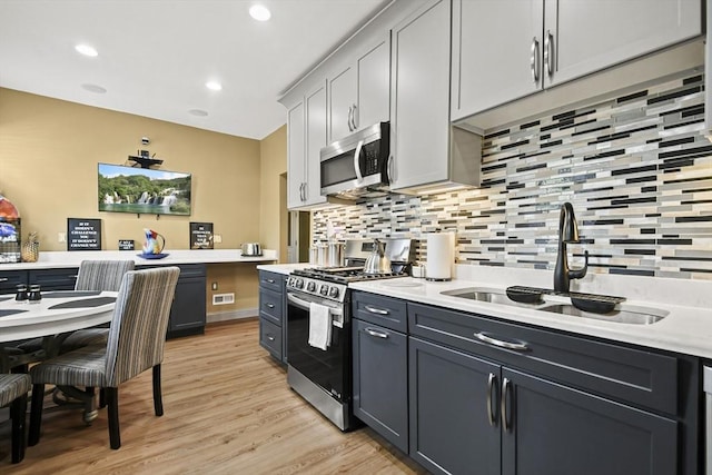 69 Greenwood St, Boston, MA 02122 - kitchen featuring stainless steel appliances, a sink, tasteful backsplash, light countertops, and recessed lighting