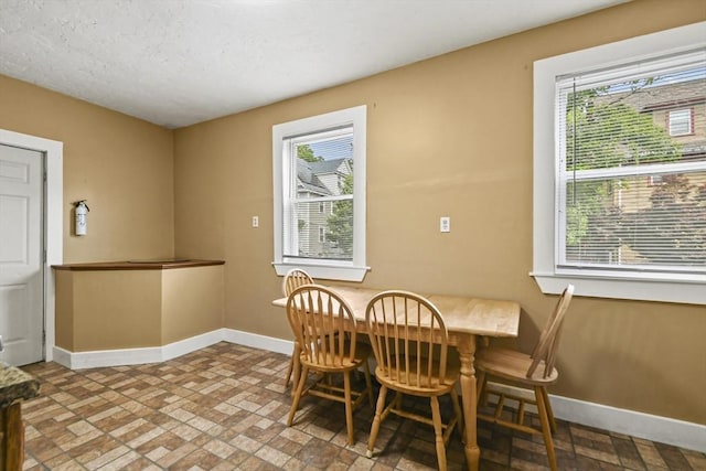 69 Greenwood St, Boston, MA 02122 - dining space featuring baseboards, plenty of natural light, and brick patterned flooring