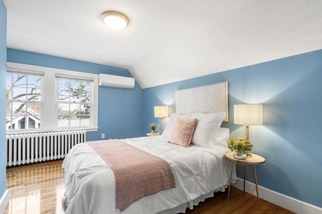 bedroom featuring baseboards, radiator heating unit, lofted ceiling, wood finished floors, and a wall mounted AC