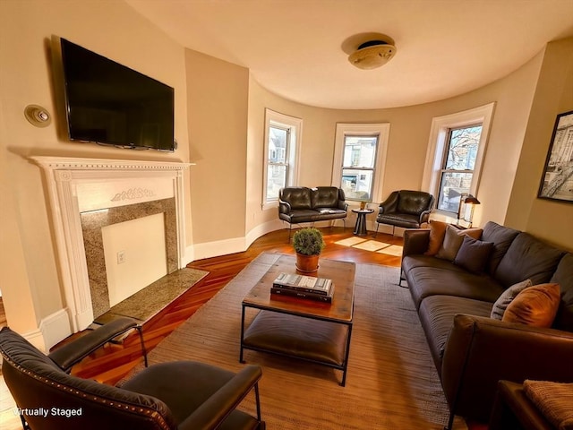 living room featuring dark hardwood / wood-style flooring and a high end fireplace