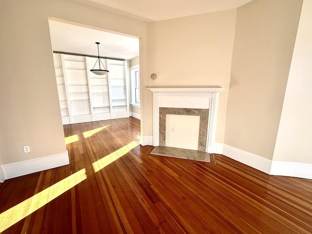 unfurnished living room featuring wood-type flooring