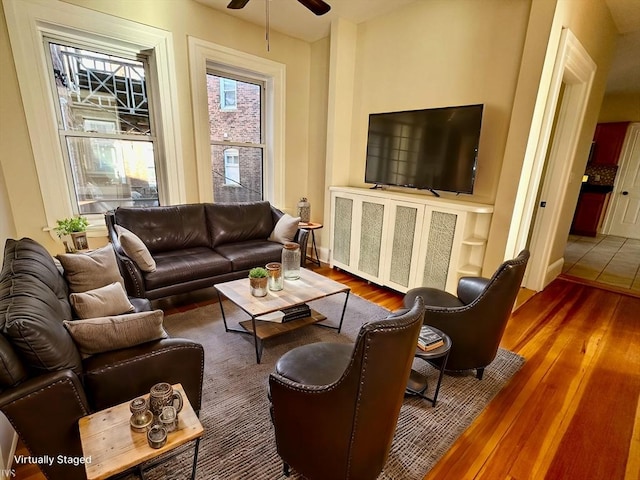 living room with ceiling fan and wood-type flooring