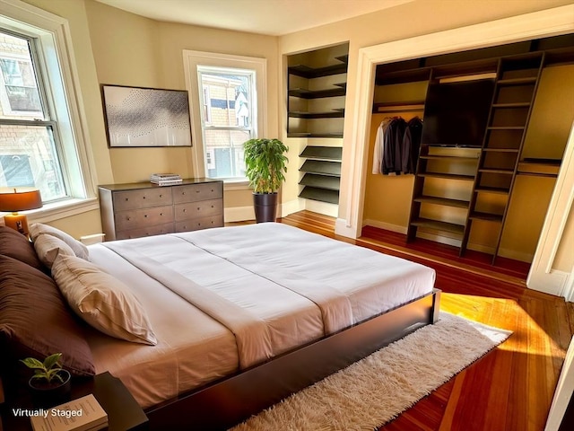 bedroom with wood-type flooring