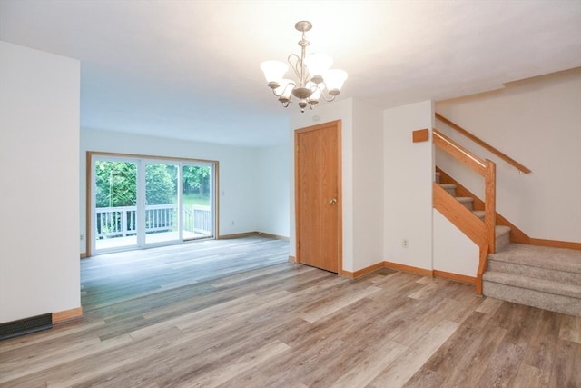 31 Blithewood Ave Unit 106, Worcester, MA 01604 - unfurnished room with a chandelier, light wood finished floors, and stairway