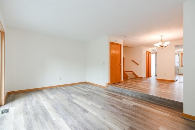 31 Blithewood Ave Unit 106, Worcester, MA 01604 - empty room with a chandelier, light wood-style flooring, and stairs