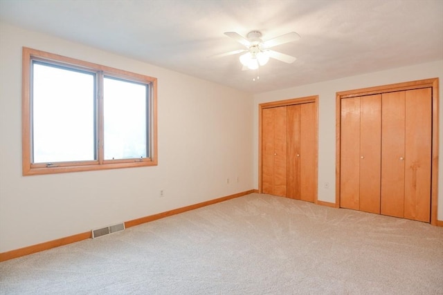 31 Blithewood Ave Unit 106, Worcester, MA 01604 - unfurnished bedroom featuring two closets, carpet floors, and a ceiling fan