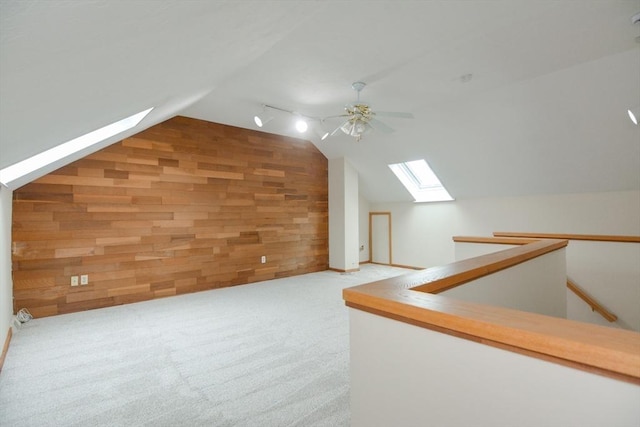 31 Blithewood Ave Unit 106, Worcester, MA 01604 - additional living space featuring a skylight, wooden walls, vaulted ceiling, ceiling fan, and carpet flooring