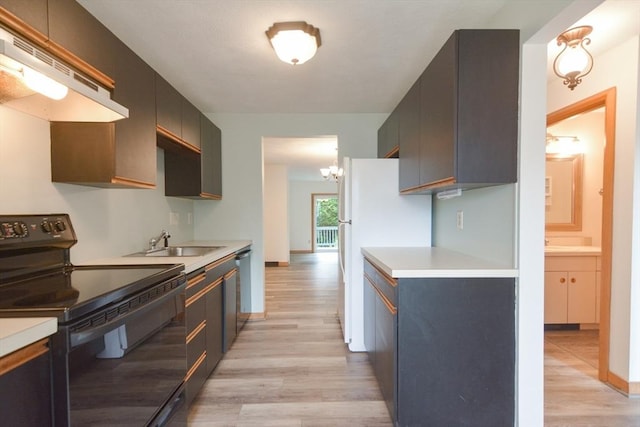 31 Blithewood Ave Unit 106, Worcester, MA 01604 - kitchen with black electric range oven, under cabinet range hood, light wood finished floors, light countertops, and freestanding refrigerator