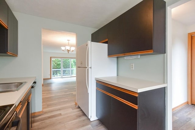 31 Blithewood Ave Unit 106, Worcester, MA 01604 - kitchen featuring light wood-style floors, light countertops, a chandelier, stove, and freestanding refrigerator