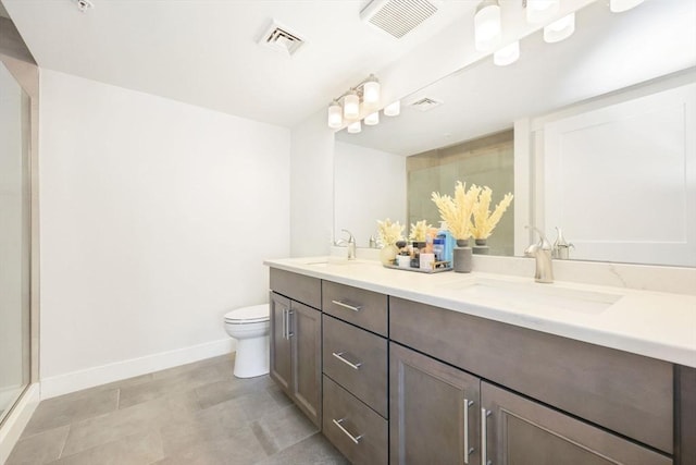 bathroom with vanity, a shower with door, and toilet