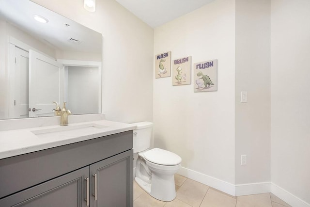 bathroom with tile patterned floors, vanity, and toilet