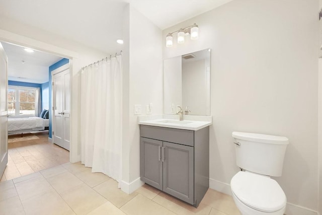 bathroom with tile patterned floors, toilet, and vanity