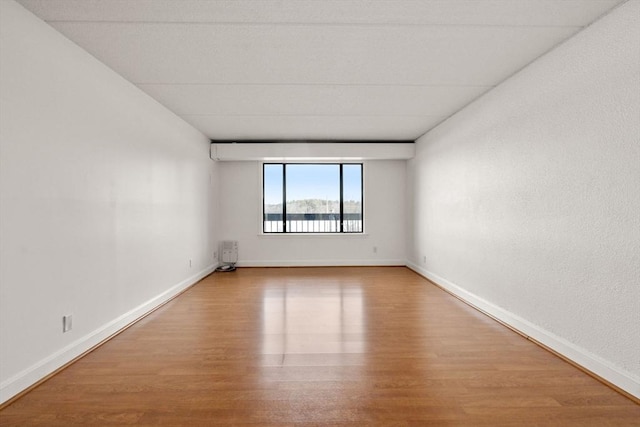 spare room with wood-type flooring and radiator heating unit