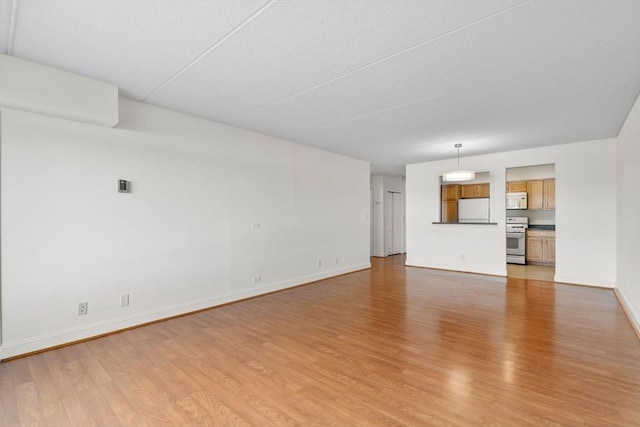 unfurnished living room with light hardwood / wood-style flooring