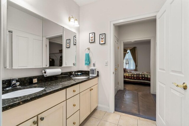 bathroom with tile patterned flooring and vanity