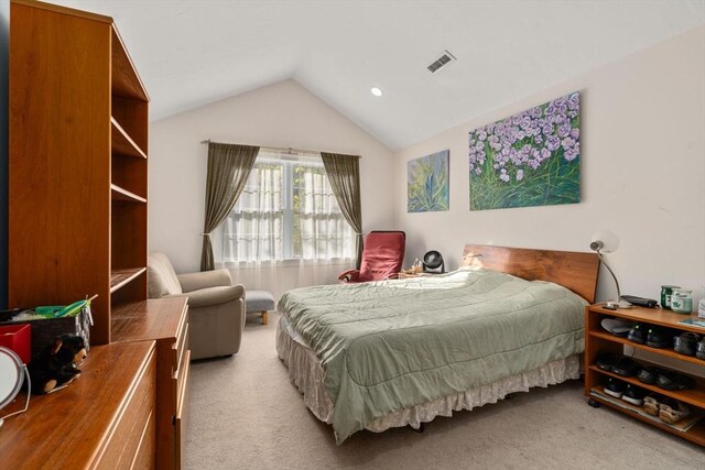 carpeted bedroom featuring lofted ceiling