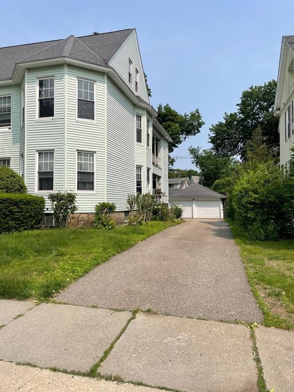 6 Newton Ave, Worcester, MA 01602 - view of side of property with a garage and roof with shingles