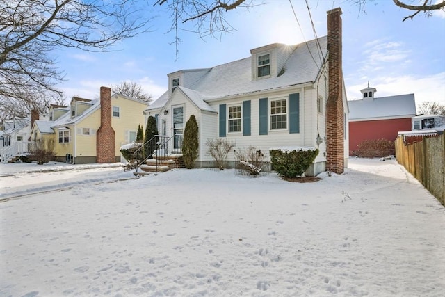 view of front of property featuring a chimney and fence