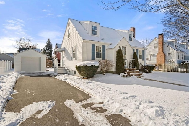 view of front of home with an outbuilding, a detached garage, fence, driveway, and a residential view