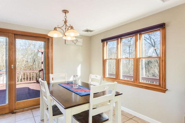 dining area featuring light tile patterned floors and a chandelier