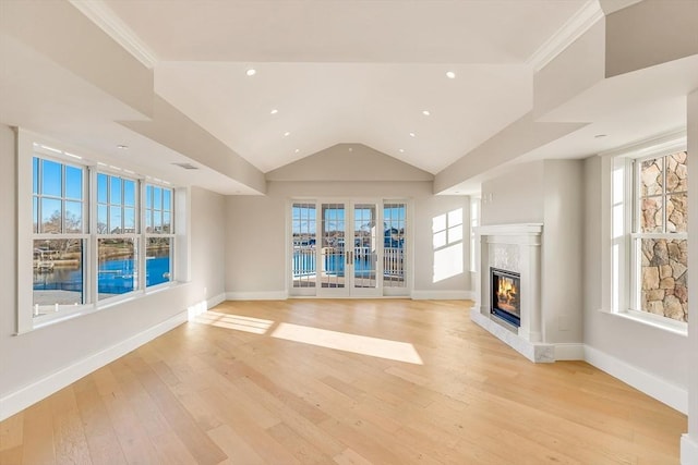 128 Elm St Unit 312, Cohasset, MA 02025 - unfurnished living room with a high end fireplace, lofted ceiling, light wood-style flooring, a water view, and recessed lighting