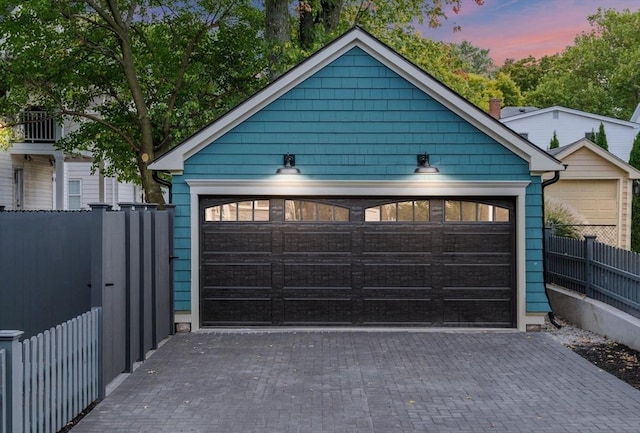 view of garage at dusk