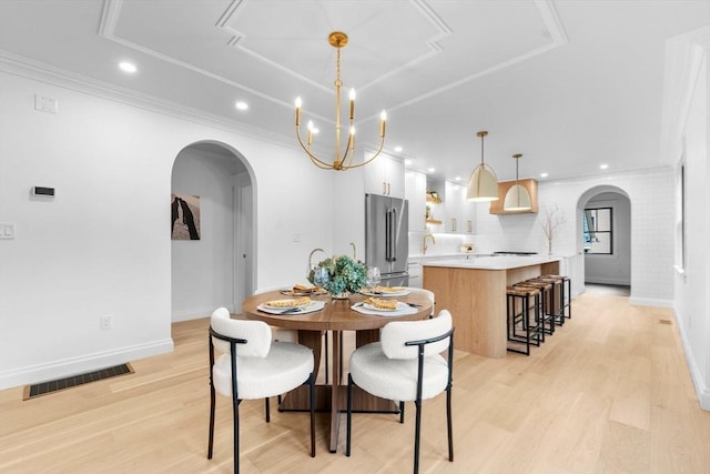 dining area with a notable chandelier and light wood-type flooring