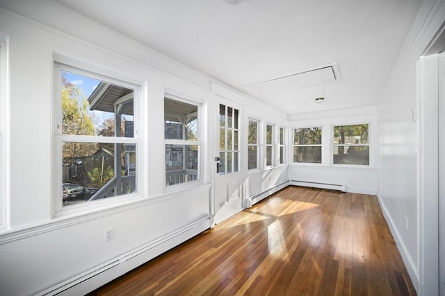 unfurnished sunroom featuring a wealth of natural light and a baseboard heating unit