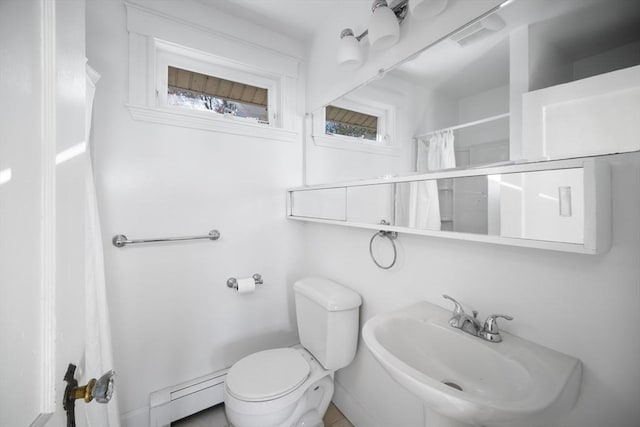 bathroom with curtained shower, toilet, sink, and a baseboard radiator