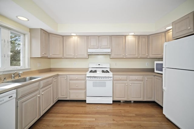 kitchen with sink, white appliances, and light wood-type flooring