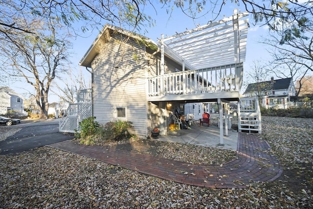 back of house with a pergola, a patio area, and a deck