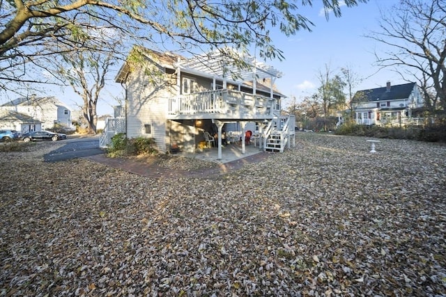 rear view of house featuring a patio area and a deck