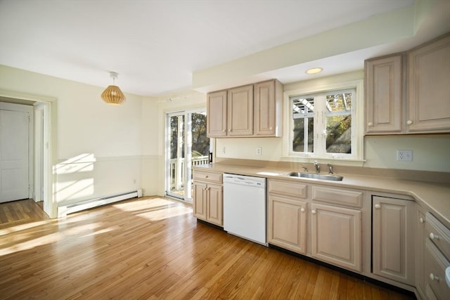 kitchen featuring sink, hanging light fixtures, a baseboard radiator, white dishwasher, and light hardwood / wood-style floors