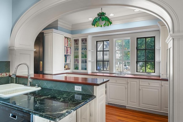 53 Abbott Rd, Wellesley, MA 02481 - kitchen featuring a sink, arched walkways, dishwasher, white cabinets, and ornamental molding