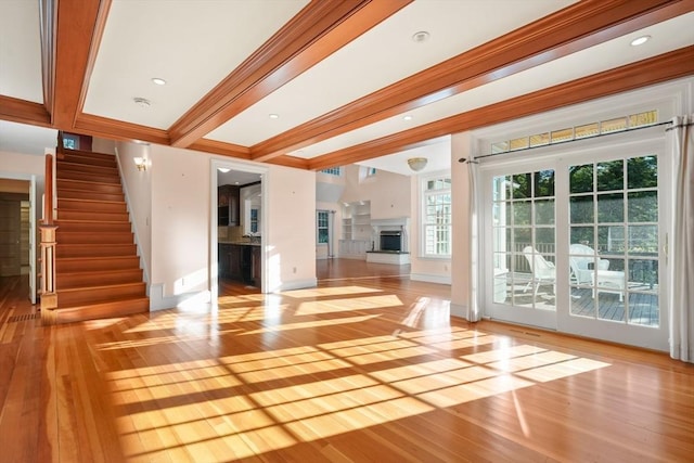 53 Abbott Rd, Wellesley, MA 02481 - unfurnished living room featuring wood-type flooring, stairway, a fireplace with raised hearth, ornamental molding, and baseboards