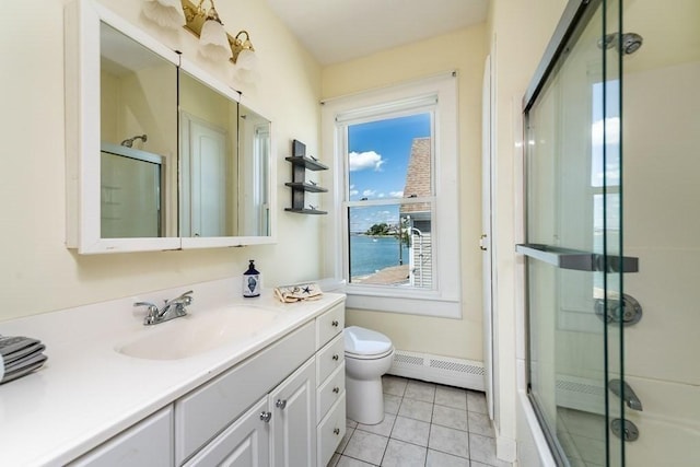 bathroom with a baseboard heating unit, a shower with door, toilet, and vanity